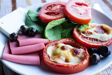 Tomatoes baked with cheese. Close-up. Selective focus. Horizontal.