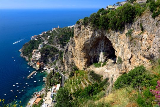 Amalfi Coast, Italy clifftop view looking down at Conca dei Marini village by the sea
