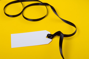 White tag with black ribbon