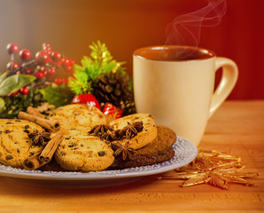 Mug with hot drink and Christmas cookies. Background with cup of chocolate, tea or coffee, festive decoration. Winter holiday concept. Beautiful cookies and bakery with cup of steaming beverage.