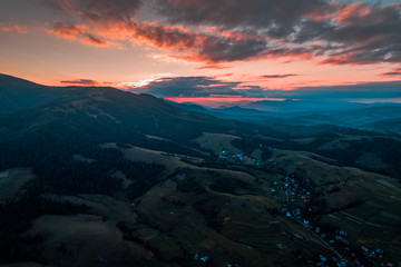 Fototapeta premium Aerial view of the village in the Carpathian mountains on the Sunset