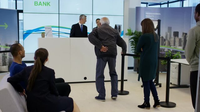  Bank customer having come in to a lot of money does celebratory dance