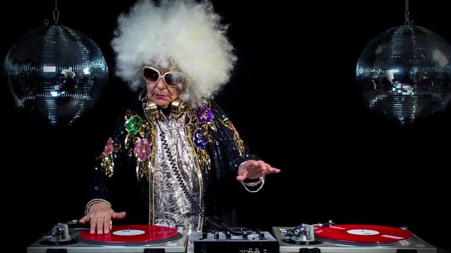 amazing DJ grandma, older lady djing and partying in a disco setting. these retired rockers will get the party going. this isa looped scratch version of the series