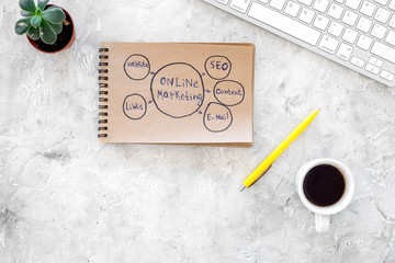 Develop a business strategy. Office table with sketch in notebook on grey background top view copyspace