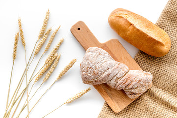 baking fresh wheaten bread on bakery work table background top view