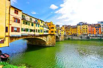 View of the Old Bridge across the Arno River in Florence on a sunny day