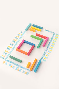 Photo of a cute geometric pattern made of colorful kid's pastel chalks