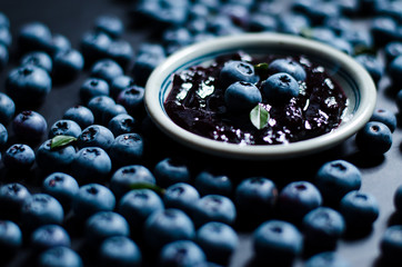 Blueberries and blueberry jam in a small bowl