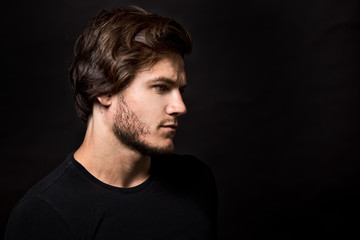 Obraz premium caucasian man wearing black tshirt and trendy hairstyle