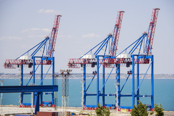 Deserted port terminal in a harbour for loading and offloading cargo ships and freight with rows of large industrial cranes to lift goods off the decks and from the holds