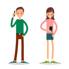 Boy and girl with mobile phone. Young man stands and talks on his mobile phone. Young girl stands and dials a number on a mobile phone or browses information on a mobile phone
