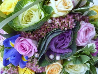 unusual bridal bouquet consisting of ornamental cabbages and cream and pale lilac coloured roses.