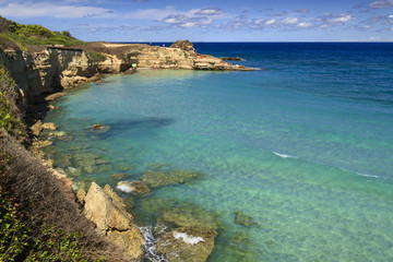 The most beautiful coast of Apulia: Torre Sant' Andrea, Otranto , ITALY (Lecce).Typical coastline of Salento: view of Punticeddha beach. Seascape with cliffs, rocky arch and sea stacks (faraglioni).