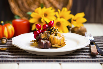Thanksgiving setting table decoration with cutlery ,plates and autumn decorations