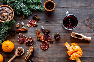Merry christmas in winter evening with warm drink. Hot mulled wine or grog with fruits and spices on wooden background top view