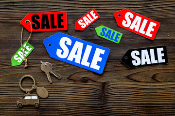 Colored sale labels on dark wooden background top view copyspace