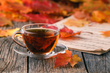 Heap of falll maple foliage on wooden table