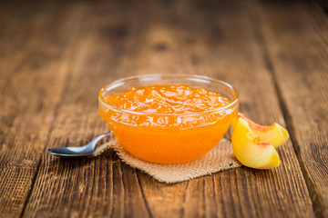 Fresh made Peach Jam on a rustic background