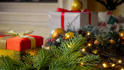 Beautiful festive background with Christmas ornaments, gift boxes and wreath