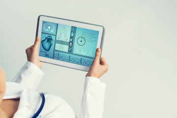 Close of female doctor hands working with tablet pc computer