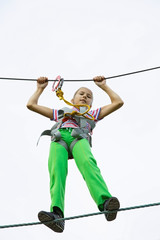 Obraz premium Teenage girl walking on a rope