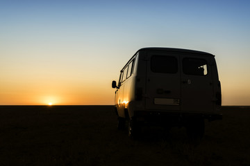 Vintage retro car in the red sunset of desert