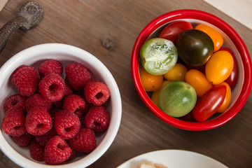 Snack idea - berry, tomato, crackers and cheese in enameled bowls