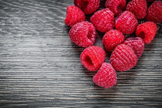 Red raspberries on wooden background