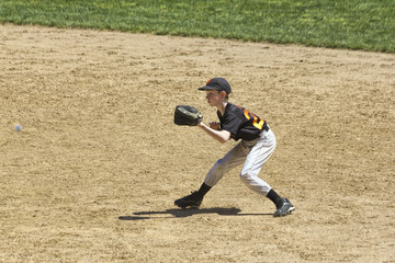 Fielder Catching Line Drive in Youth Baseball Game