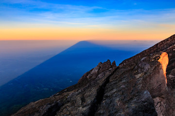 Mount Agung volcano casts its huge shadow over the island of Bali at sunrise