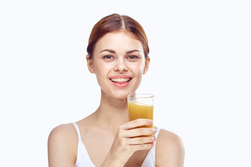 woman smiling and holding a glass of juice, orange, peach