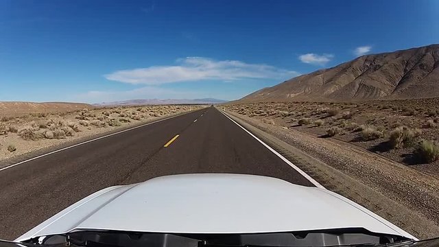 Fast drive on straight road through desert