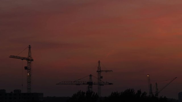 Work on the construction site at sunset,time-lapse.
