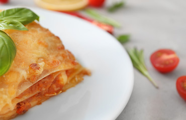 Plate with tasty lasagna on table
