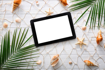 Composition with tablet on wooden background. Summer vacation concept