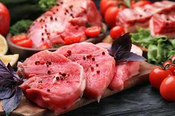 Fresh raw meat on wooden board, closeup