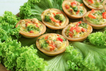 Broccoli quiche tartlets on salad leaves