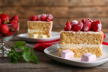 Delicious cake decorated with strawberries on plate