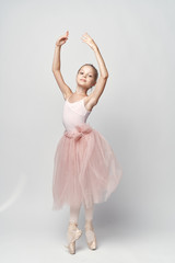 Fototapeta na wymiar girl ballerina standing in a beautiful rack