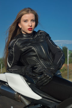 Sexy biker girl in a leather jacket
