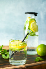 Delicious refreshing water with cucumber in glass on table