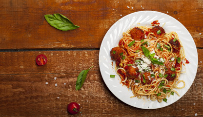 Spaghetti pasta with meatballs and tomato sauce, top view