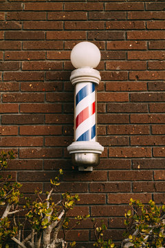 barber pole on a brick wall