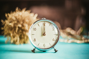 Small old alarm clock and christmas decorations