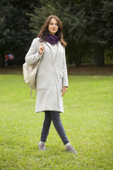 Portrait of a young beautiful woman in gray coat