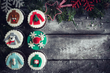 Christmas decorative cupcakes on wooden background with blank space