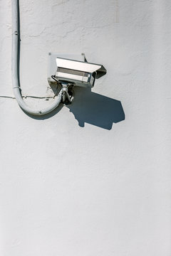 Security camera on a white wall