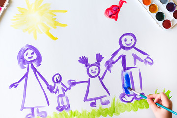 Child's hand paints sketch of the family