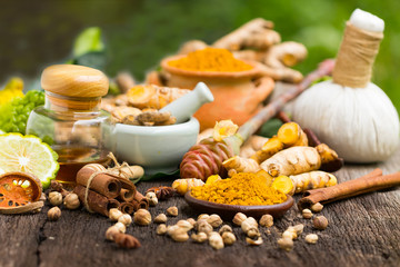 Turmeric powder,Turmeric in Mortar Grinder drugs and ingredient herbs on wooden background