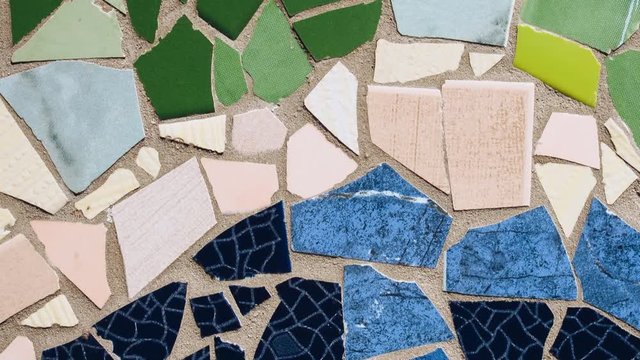 Arbitrary ornament of ceramic tiles. Fragment of ceramic mosaic in Barcelona. Spain, Catalonia.